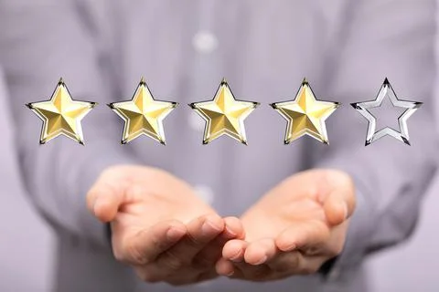 3d render design of four golden stars rate on hands Foto stock