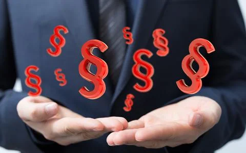 3D render of floating paragraph law and justice symbols over a lawyer's hands Stock Photos