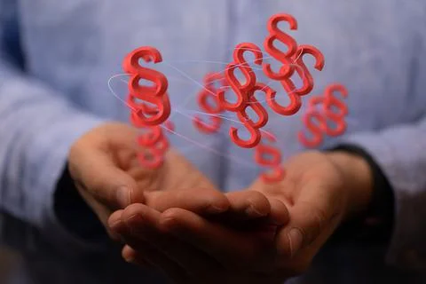 A 3D render of floating red paragraph law and justice symbols over a lawyer's Stock Photos
