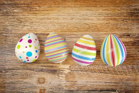 3d render - four colorful easter egg on dark wood table Stock Illustration