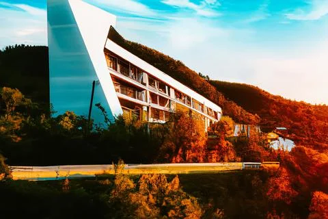 3D render of a futuristic modern triangular building design in rural mountains Ilustração Stock