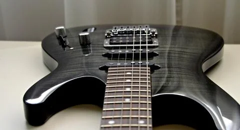 3d render greyscale shot of a brand new bass guitar on the table Stock Photos