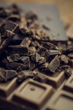 3D render is showing broken dark chocolate bar on wooden tabletop with shards Stock Illustration