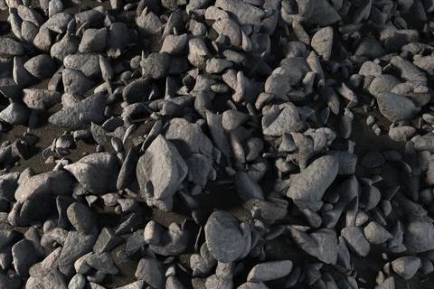 3D render is showing irregular dark grey stones overlapping on coarse gravel 写真素材