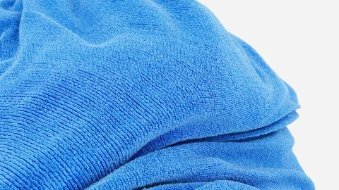 3D render of wavy in air blue terry towel on white background Stock Footage 258570145