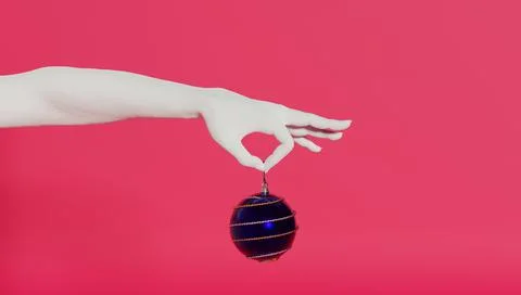 3d render of a woman's hand holding a christmas ball. Stock Photos