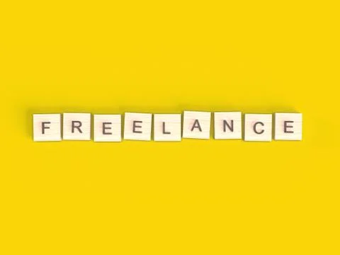 3d render. Word freelance. Top view wooden blocks with letters on yellow surface Illustrazione stock