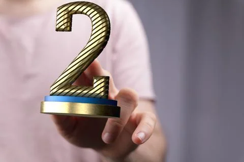 3D rendered 2nd place trophy with a real person in the background 스톡 사진