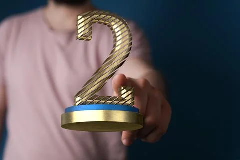 3D rendered 2nd place trophy with a real person in the background 스톡 사진