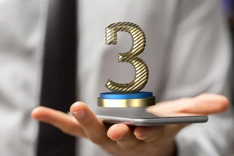 3D rendered 3rd place trophy hovering over a smartphone on a man's hand 스톡 사진