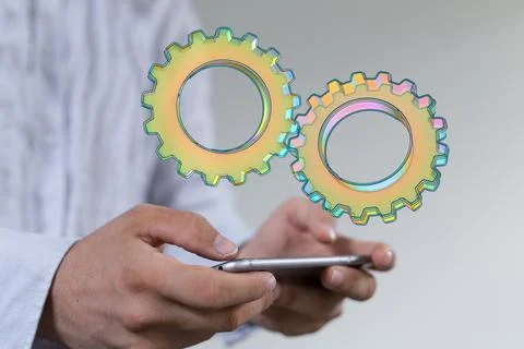 3D rendered cogwheels flying over the smartphone - mobile settings Stock Photos