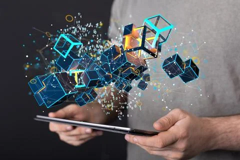 3D rendered cubes hovering over the man's hands holding a tablet. Stock-Fotos