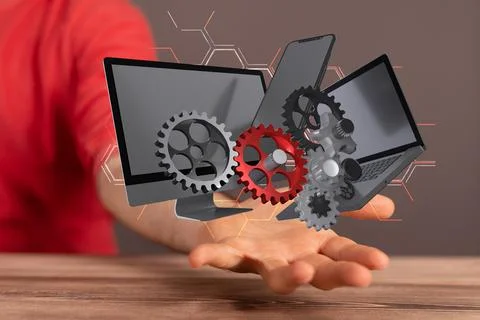 3D rendered gears and computers held in a person's hand Fotos de archivo