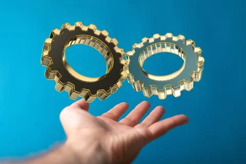 A 3D rendered gears icons hovering over a man's palm isolated on a blue backg Stock Photos