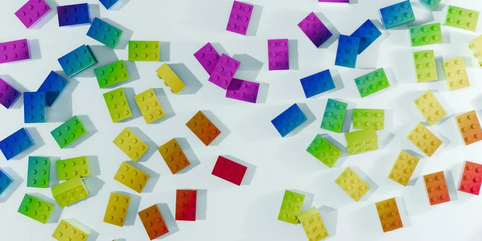 3d rendered rainbow colored building blocks scattered on white surface Ilustración de archivo