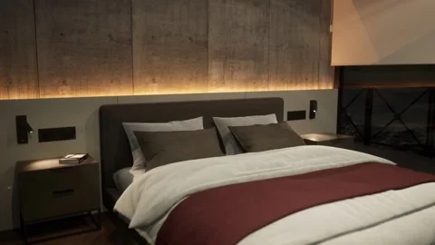 3d-rendering. A bed in a hotel room in a modern style in the evening. Stock Footage 222348502