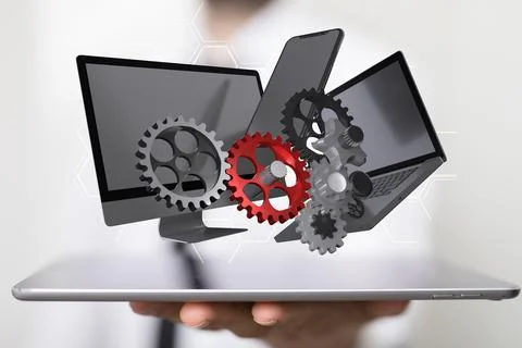 A 3d rendering of computer and smartphone and gears, above a laptop, held by  Stock Photos