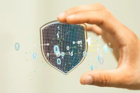 A 3d rendering of a cybersecurity shield in a binary coding held by a human h Stock Photos