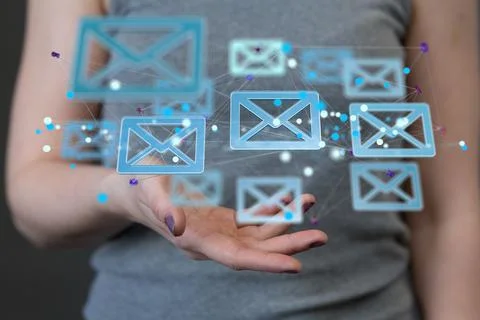 A 3D rendering of digital envelopes floating on hand- online communication co Stock Photos