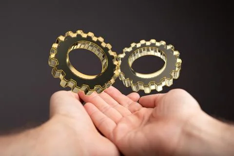 A 3D rendering of digital gears with hand touching it from behind-business ge 스톡 사진