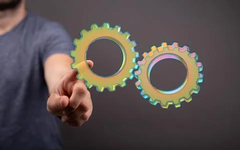 A 3D rendering of digital gears with hand touching it from behind-business ge 스톡 사진