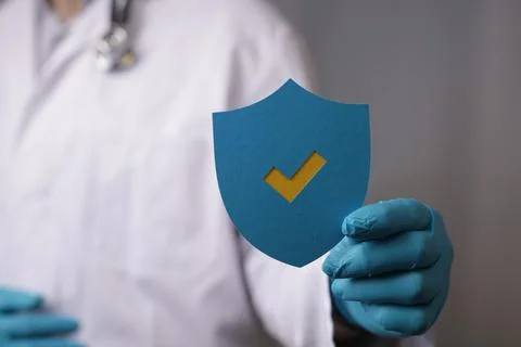 3D rendering of a doctor's hand holding a shield- concept for medical help Foto stock
