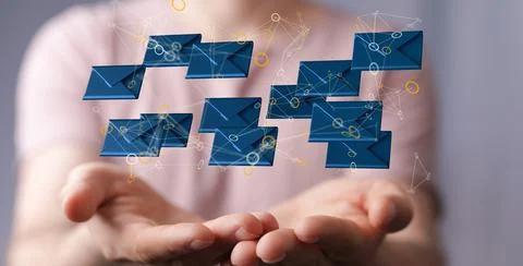 A 3D rendering of email icons floating on a woman's hand against a blurred ba Foto stock