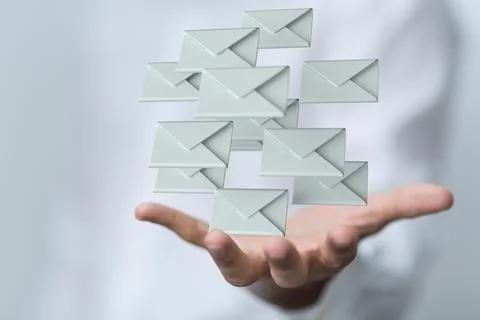 3D rendering of emails in a hand; electronic communication concept Stock Photos