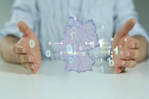 3D rendering of Germany map with binary codes floating in between human hands Stock Photos