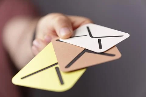 A 3D rendering of hand holding digital envelopes cardboard- online communicat Stock Photos