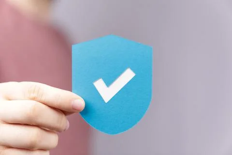 3D rendering of hand holding a shield with check- cyber protection concept Stock Photos