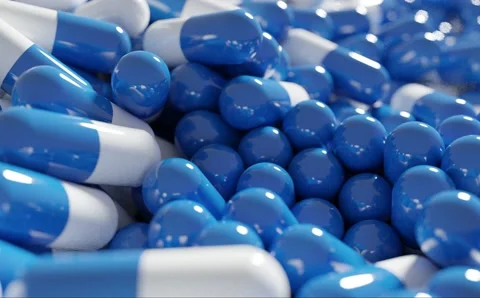 3D rendering heap of white and blue capsule pills Stock Footage 164975855
