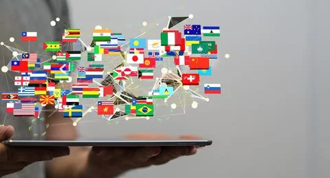 A 3D rendering of interconnected flags on a man's tablet - global networking  Stock Photos