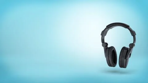3d rendering of a large black wireless padded headphones in front view on blue Stock Illustration