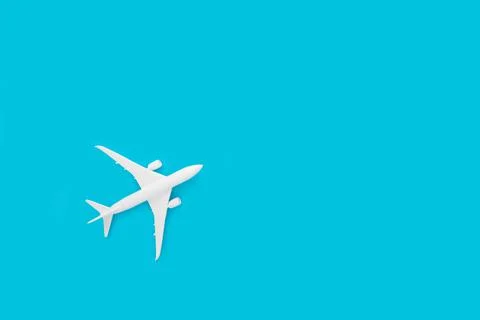 A 3D rendering of a miniature airplane isolated on a blue background with fre Stock Illustration