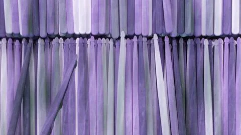 3d rendering of multiple upright purple and white drumsticks forming a pattern 스톡 일러스트