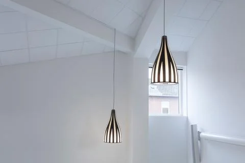 3D rendering of pendant lamps hanging from a white ceiling for house interiors Ilustración de archivo