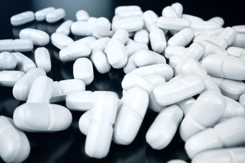 3D rendering pills, white pills scattered on black background. Medicines for Stock Illustration