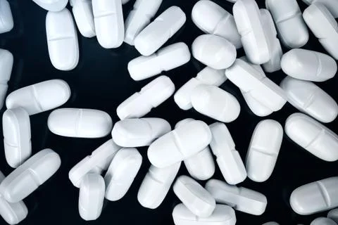 3D rendering pills, white pills scattered on black background. Medicines for Stock Illustration