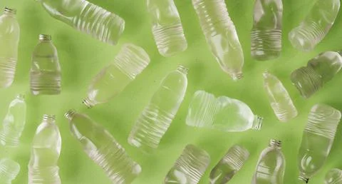 3D rendering of plastic bottles scattered on green background Stock Photos