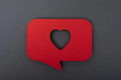 3D rendering of a red heart icon in a thinking cloud on a black surface Stock Photos