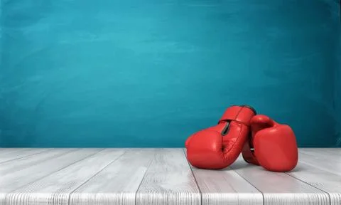 3d rendering of two red boxing gloves lying on a wooden desk in front of a blue Stock Illustration