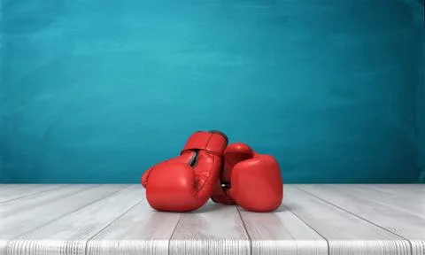 3d rendering of two red boxing gloves lying on a wooden desk in front of a blue Stock Illustration