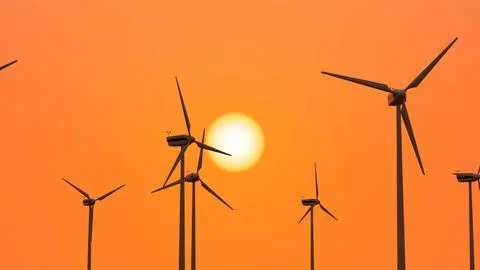 3d rendering of wind turbines on orange sunset sky background with bright sun Stock Illustration