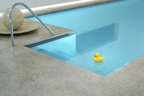 3d rendering of a yellow rubber duck in an indoor pool Stock Photos
