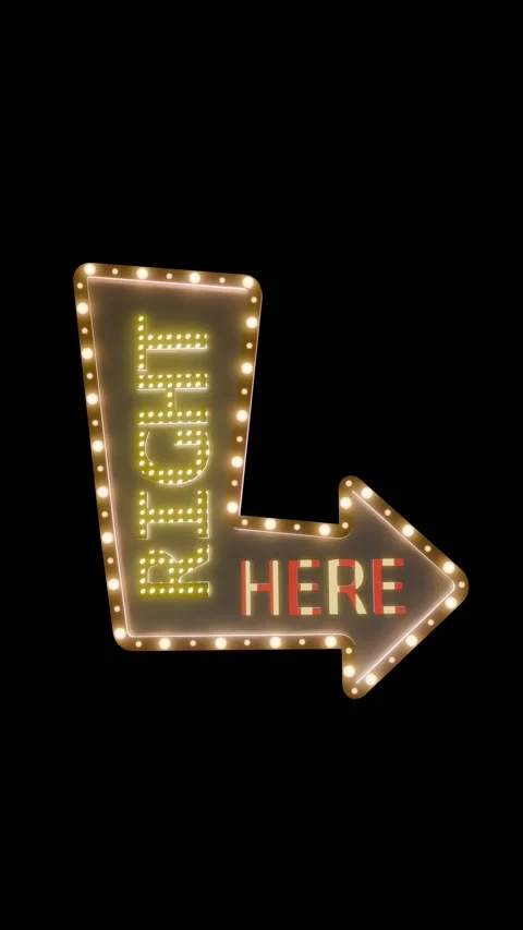 A 3d retro arrow marquee sign reading "RIGHT HERE" on a black background Stock Footage 340443749