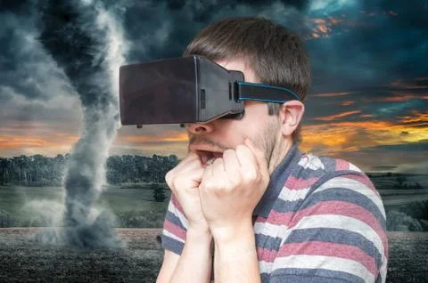 3D simulation concept. Man is wearing virtual reality headset and is scared f Stock Photos
