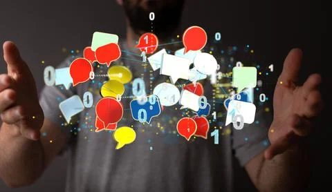 3d speech bubble icons hovering between the man's hands. Stock Photos