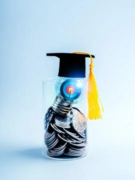 3d Target icon inside light bulb wearing graduation hat, on many coins in g.. Stock Photos