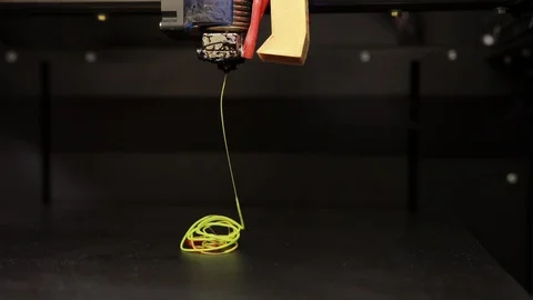 3D technology the printer prints part from plastic cable thread close up yellow Stock-Footage 124375249